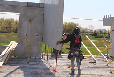 Workers guiding in concrete slab